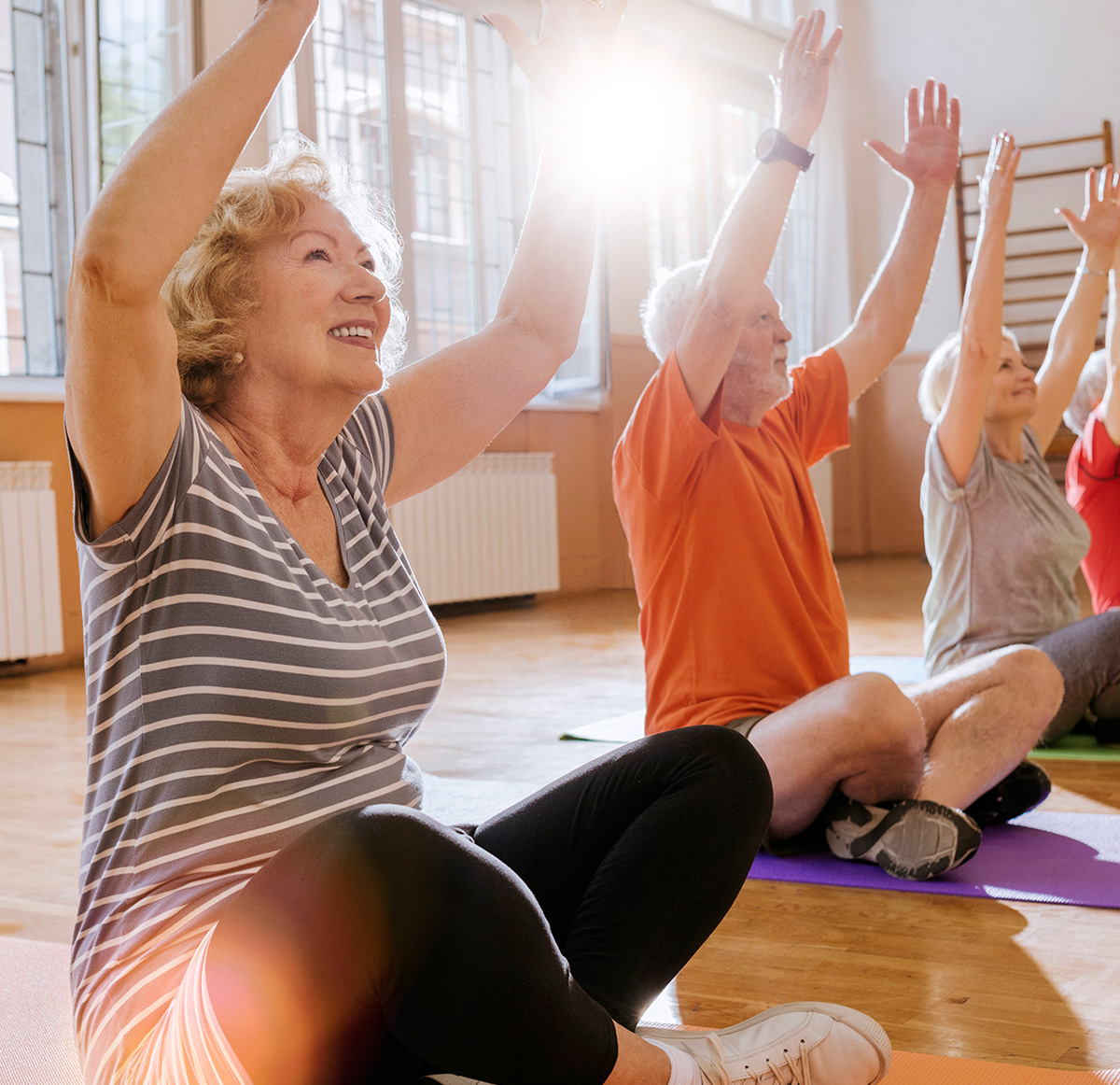 Elderly people doing recreational yoga