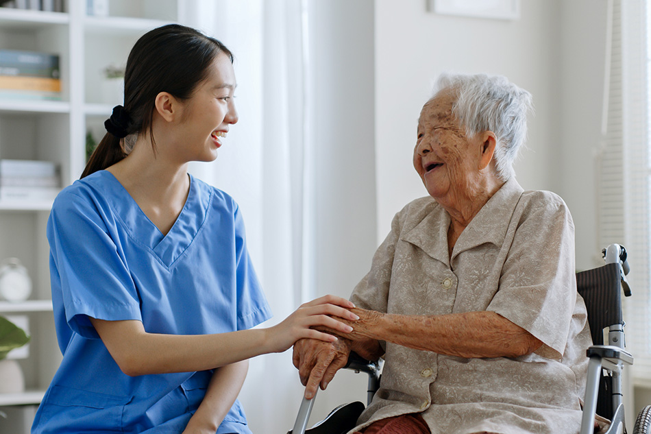 Nurse holding hands with senior man